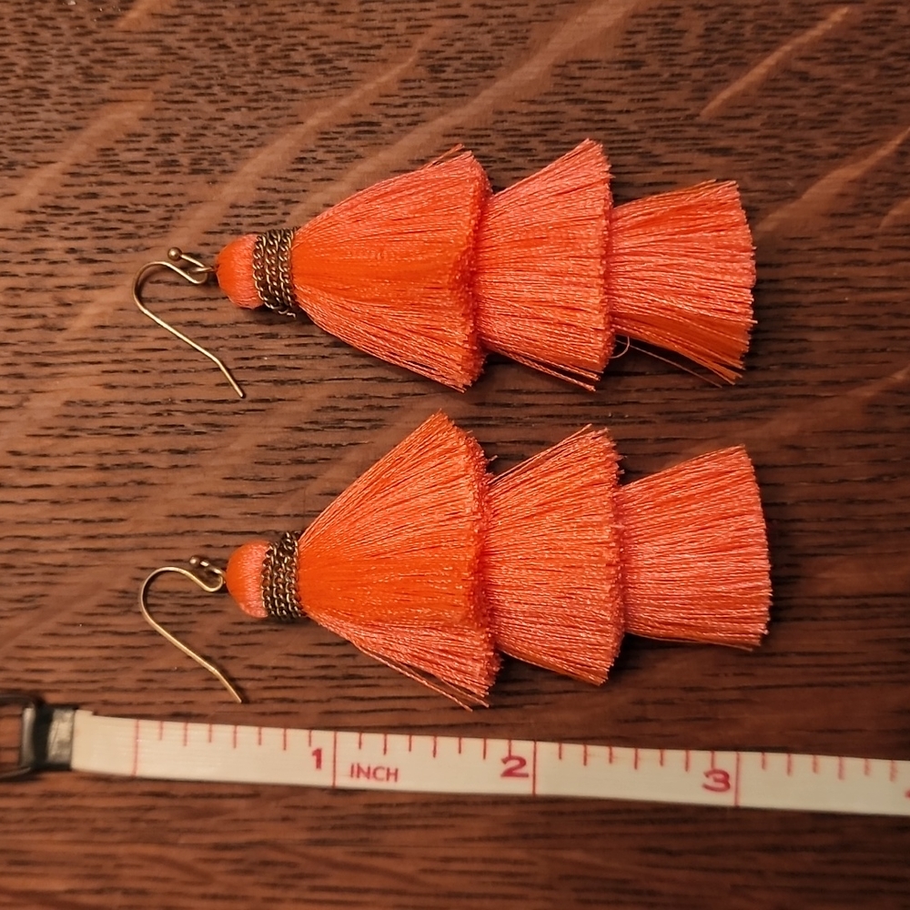 Women's orange three tiered tassel earrings
